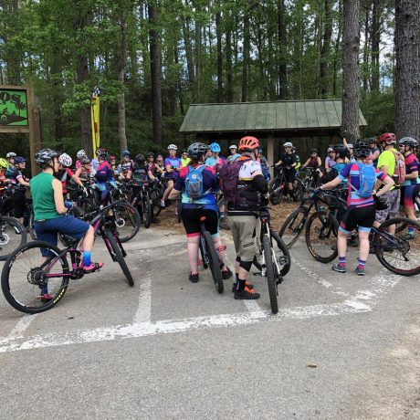 people lining up at trailhead with bicycles