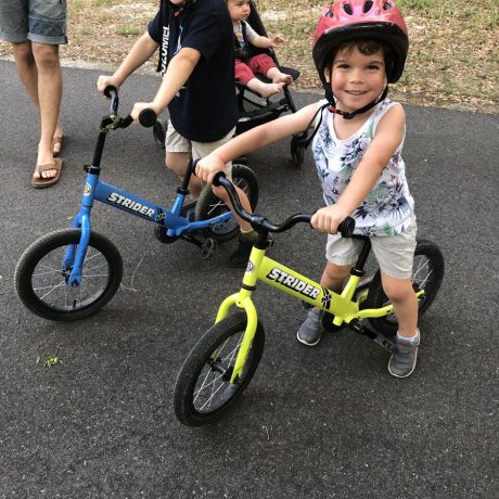 kids on small bikes smiling